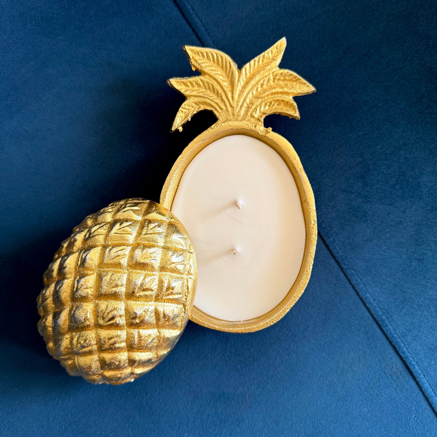 Gold pineapple-shaped candle holder with a white candle